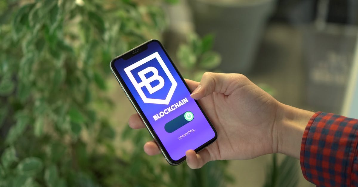 Hand holding a smartphone displaying a blockchain stablecoin app, illustrating the Mastercard and Yellow Card stablecoin payments partnership across EEMEA.