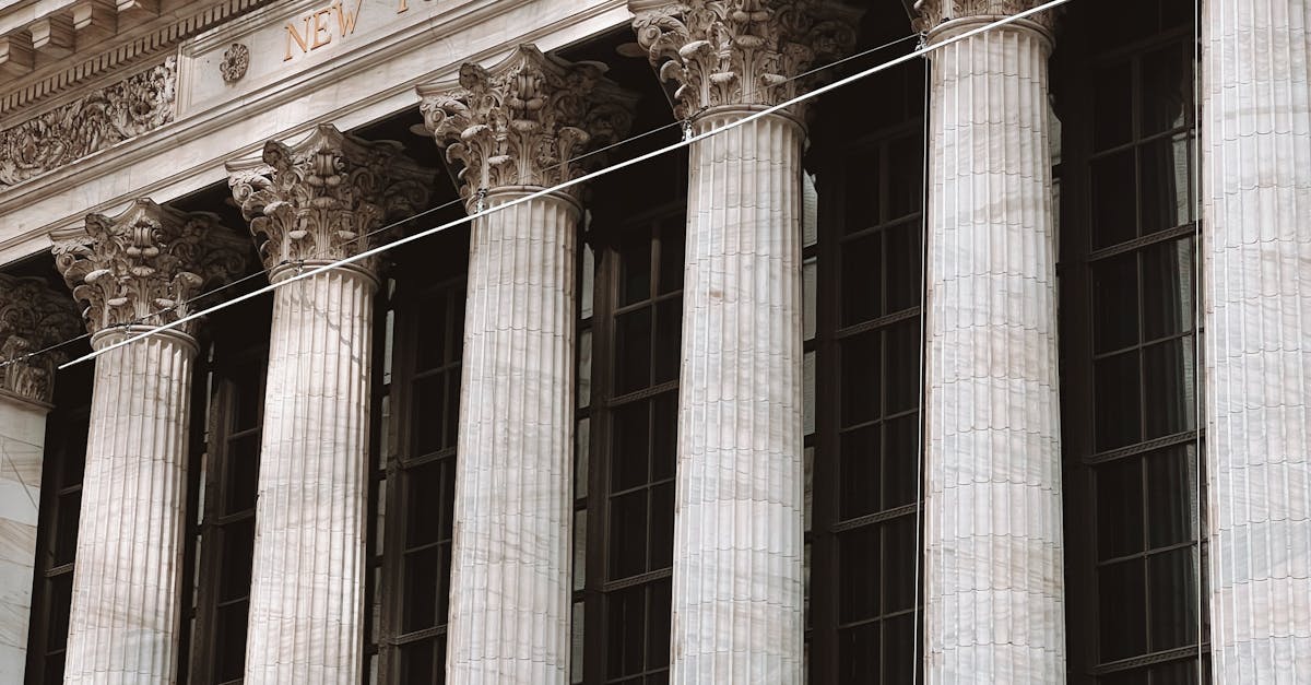 Detailed view of the New York Stock Exchange facade with American flags and columns